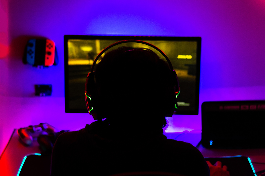 Man with Headphones Playing Computer Game